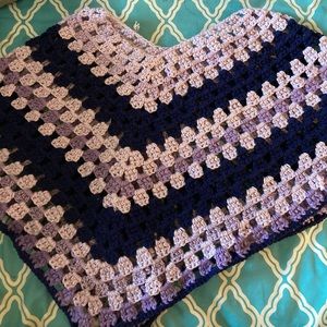 This is a woman's handmade crocheted pancho that keeps you warm!